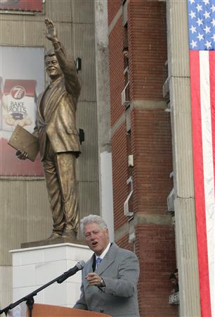 Former U.S. President Bill Clinton speaks in front of his statue in the capital Pristina